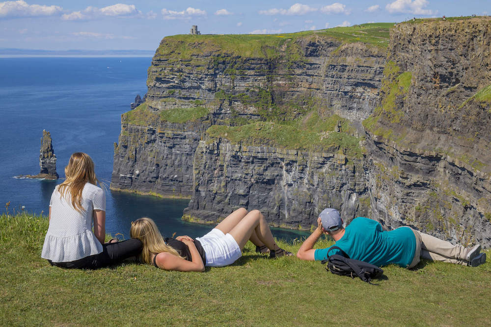 Girls resting and looking at the views at Cliffs of Moher