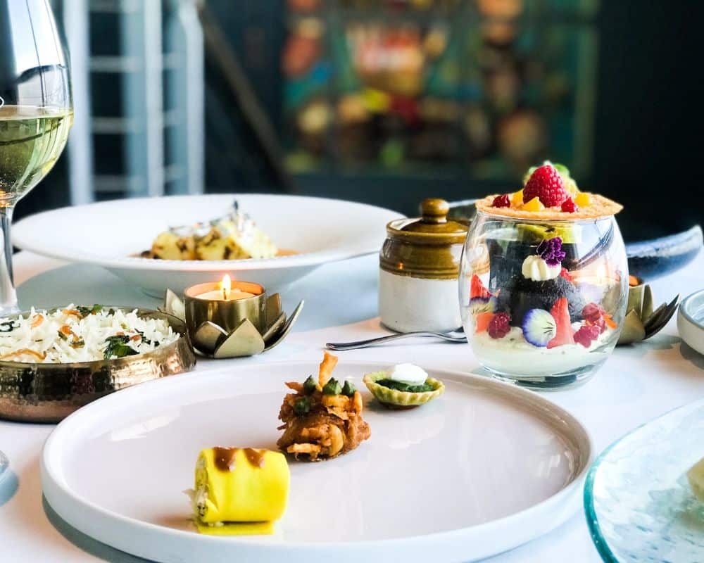 The photographs show a spread of festive menu at Ananda - a fine dining restaurant in Dublin. The Diwali tasting menu is a good way to experience festive food and Diwali in Dublin.  Photographs show food plated in beautiful way along with candles and earthen diyas