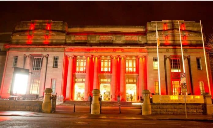 A state building all lit up in red lights for the Chinese Lunar New Year