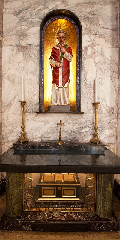  The Shrine of St. Valentine at  Whitefriar Street Church -you see the idol of St. Valentine and two ornate candles plus a cross
