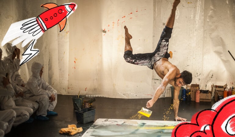 Camiel the acrobatic painter as he twists, jumps, and rolls in paint and children in space suit costumes look on - a part of the Festival of Children 2023