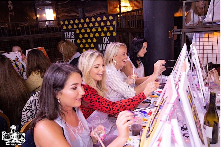 Women with canvases, paints and brushes and prosecco 