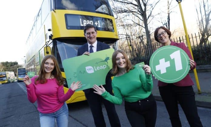 You see a bus with a man in a suit and young people holding cards that say +1 and a Leap card poster of sorts - this is an offer for St. Brigid's Day Bank Holiday weekend