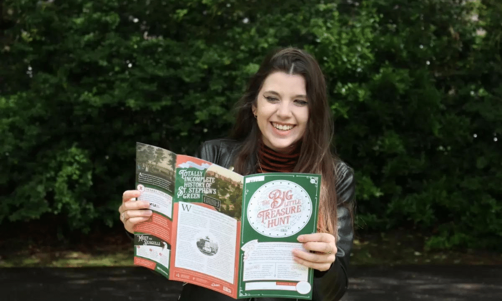 A woman reading from a brochure on the Big Treasure Hunt and more for St. Patrick's Day