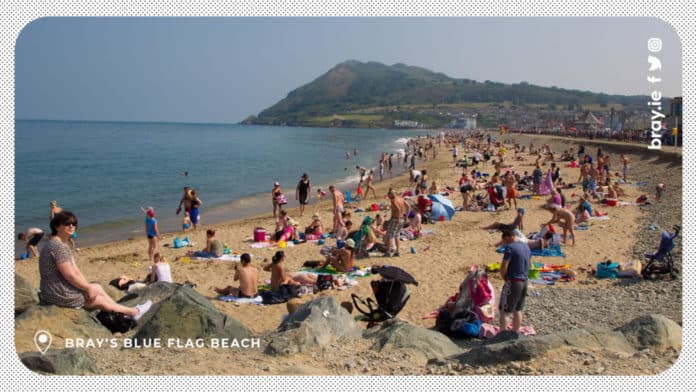 People at Bray's Blue Flag beach relaxing on a clear day