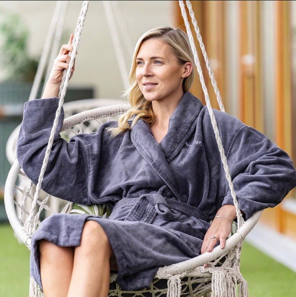 A woman in a wicker chair swing at the spa