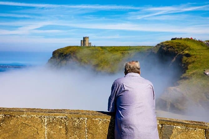 A man views Caherconnell Stone Fort on a Cliffs of Moher Day trip 